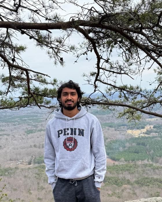 Rohit Jagga outdoors with a scenic overlook in the background